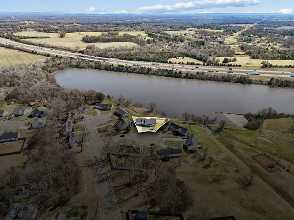 an aerial view of a house with a lake view