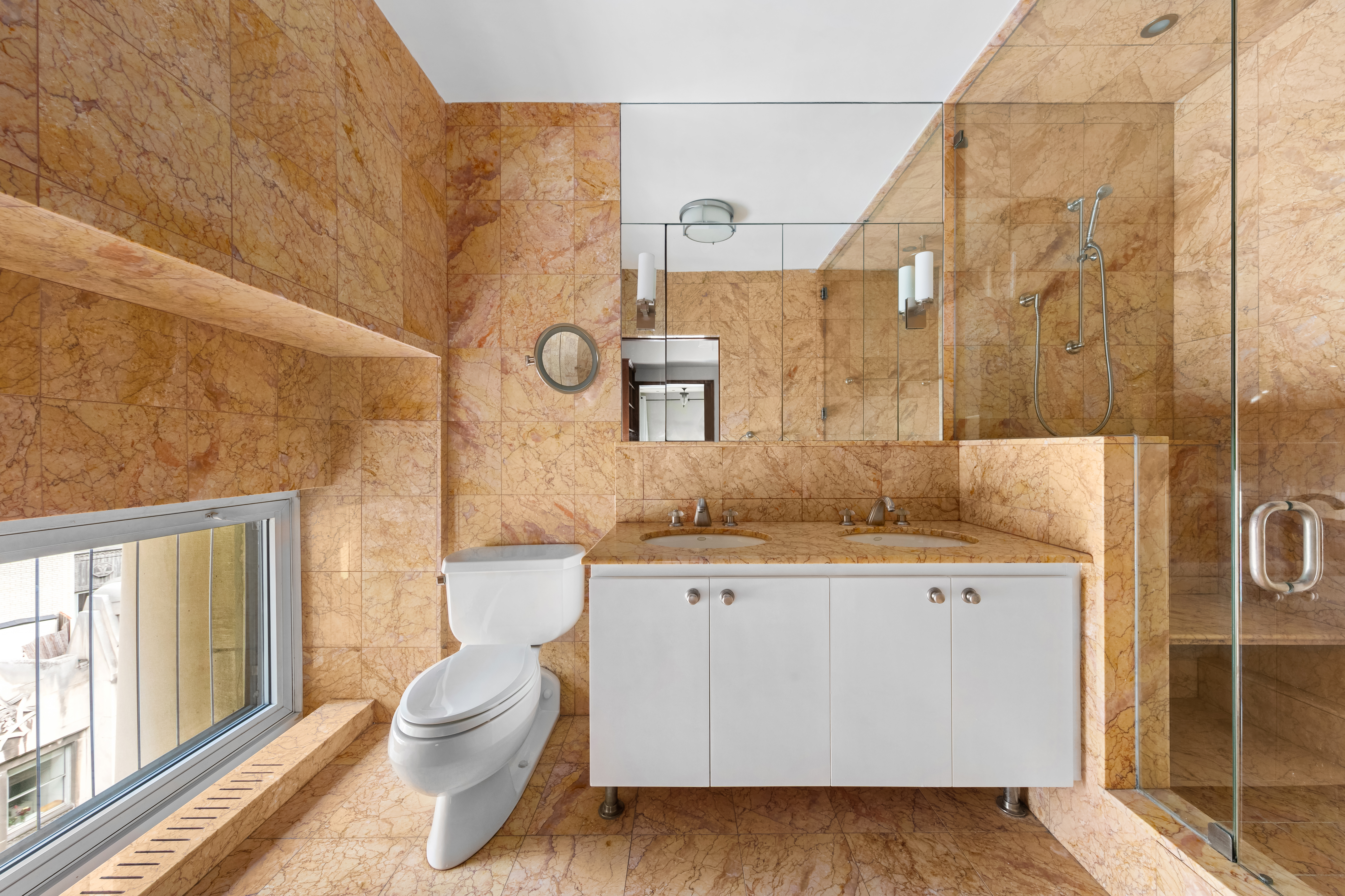 3 Hanover Square, Unit 22A Manhattan, NY 10004 - Photo 8 of 19 a bathroom with a granite countertop sink a toilet and shower