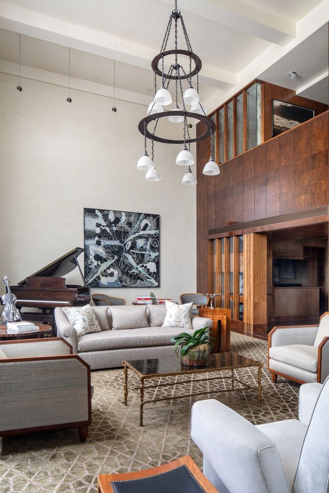 a living room with furniture and a chandelier