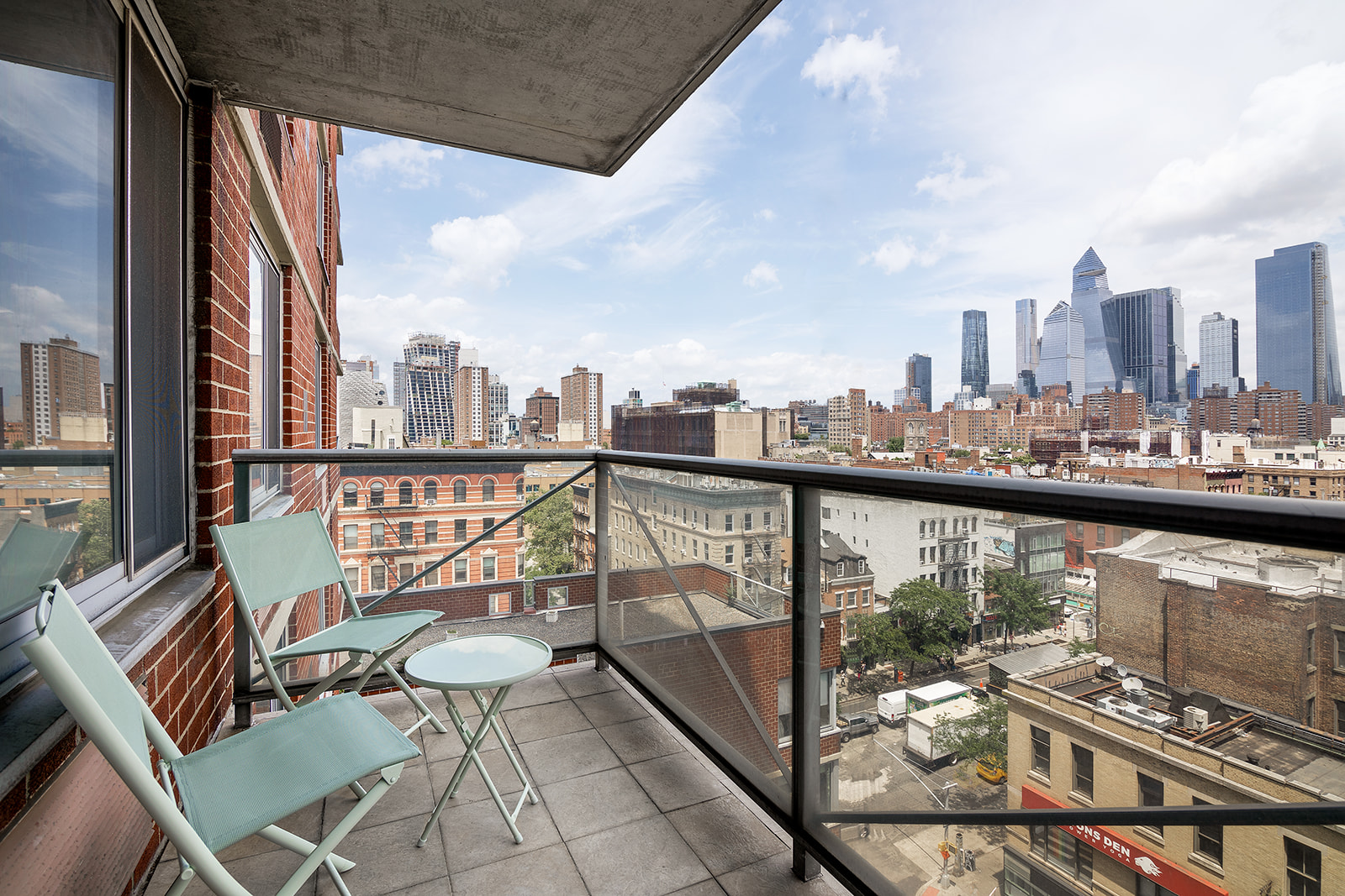 270 West 17th Street, Unit 9A Manhattan, NY 10011 - Photo 3 of 6 a view of a balcony with wooden chairs