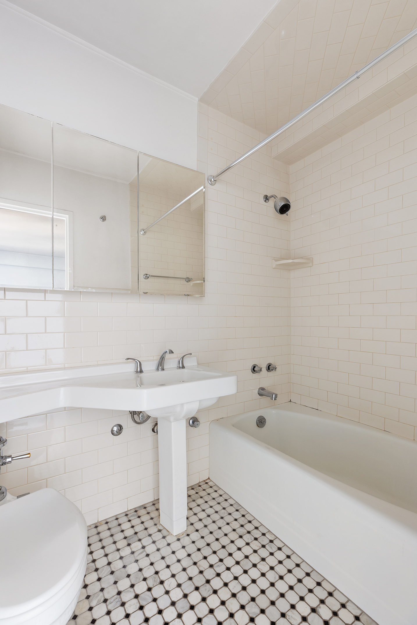 120 East 90th Street, Unit 16E Manhattan, NY 10128 - Photo 12 of 15 a bathroom with a sink a toilet and shower