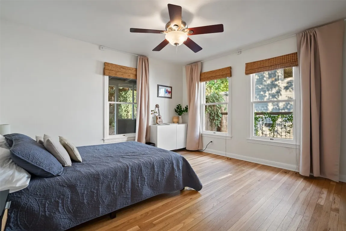a spacious bedroom with a bed and a large window