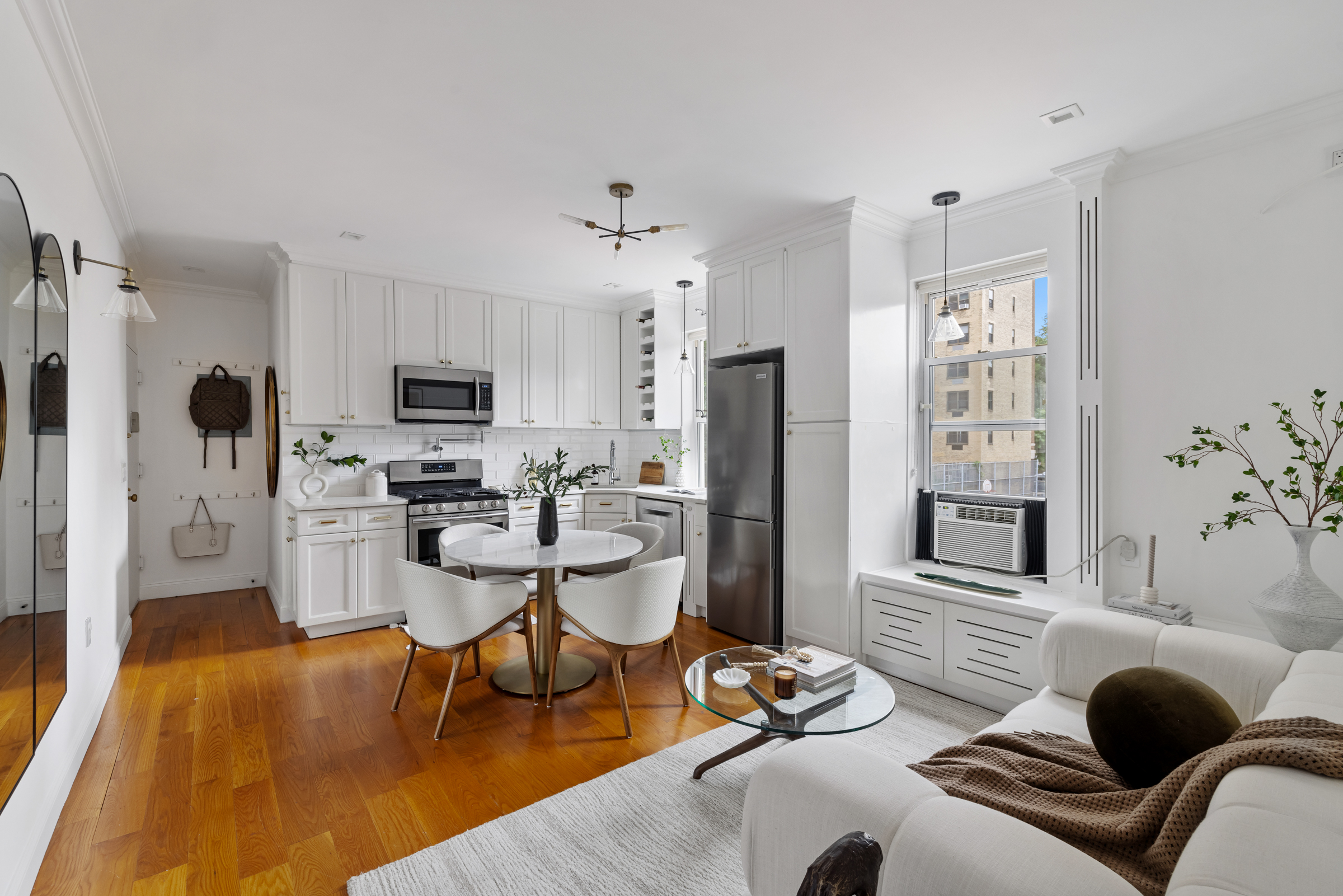 328 West 96th Street, Unit 2C Manhattan, NY 10025 - Photo 7 of 15 a living room with stainless steel appliances furniture a fireplace and a flat screen tv
