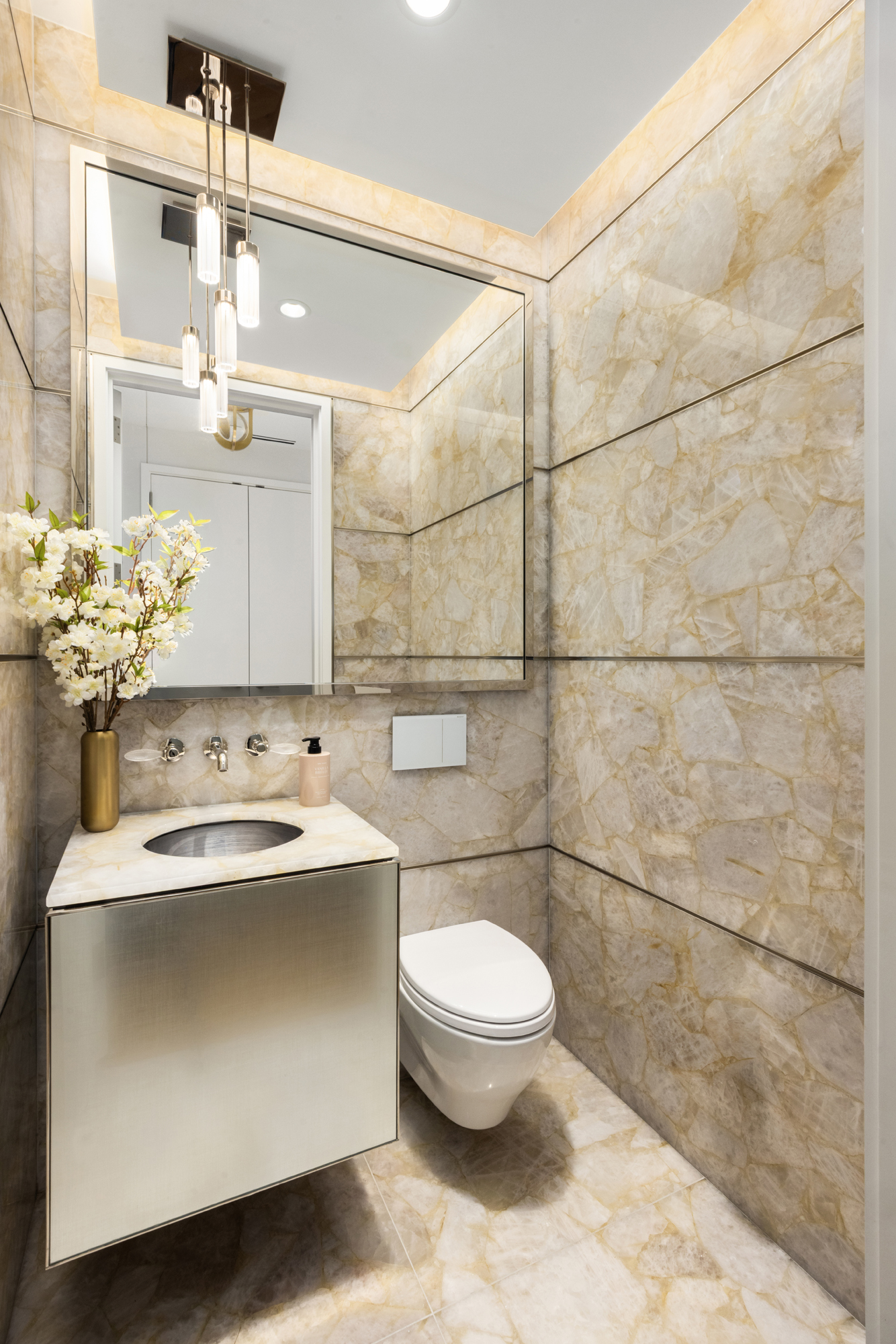 217 West 57th Street, Unit 34F Manhattan, NY 10019 - Photo 14 of 25 a bathroom with a sink a toilet and shower