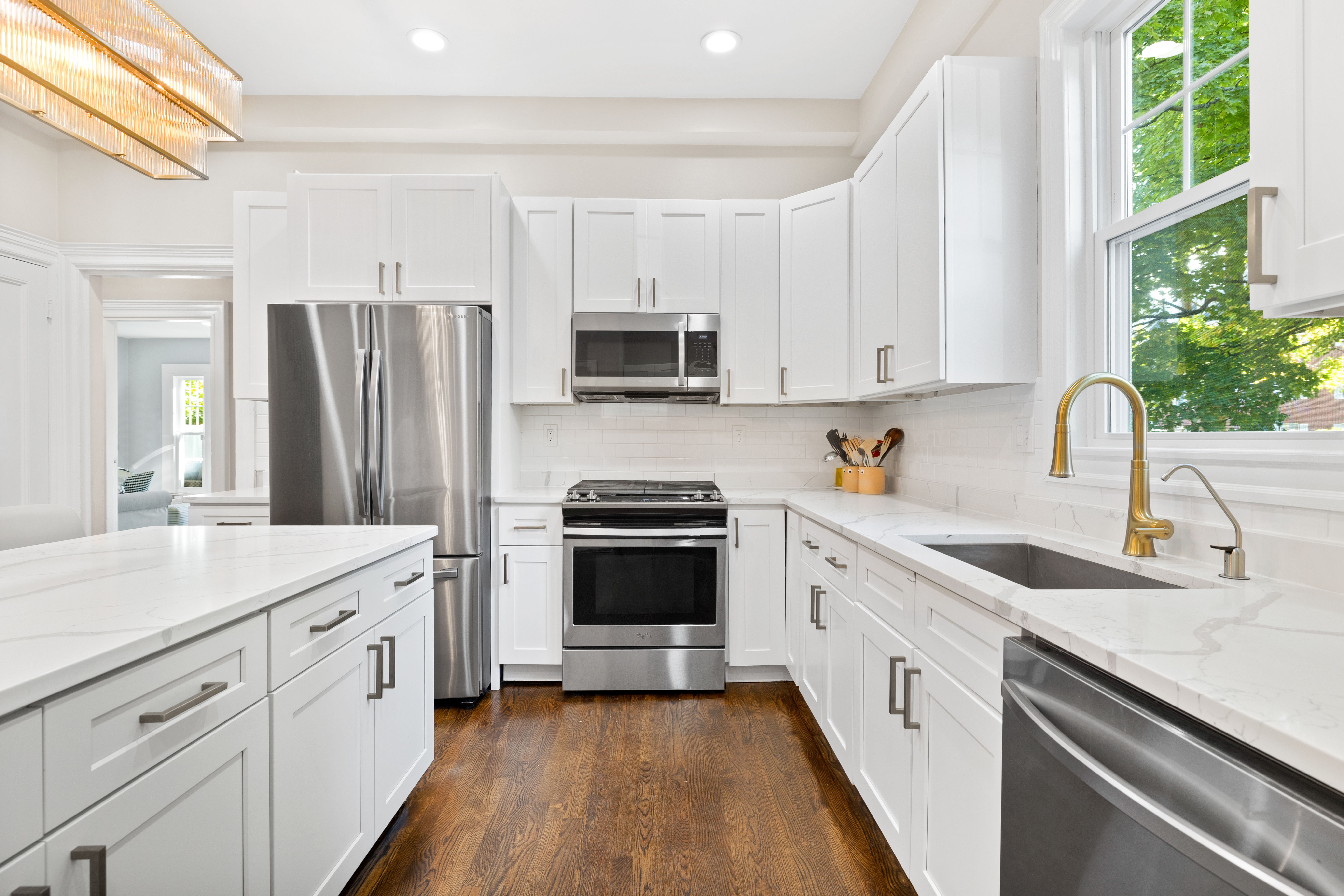 90 Maple Place Dedham, MA 02026 - Photo 8 of 40 a kitchen with white cabinets and white appliances