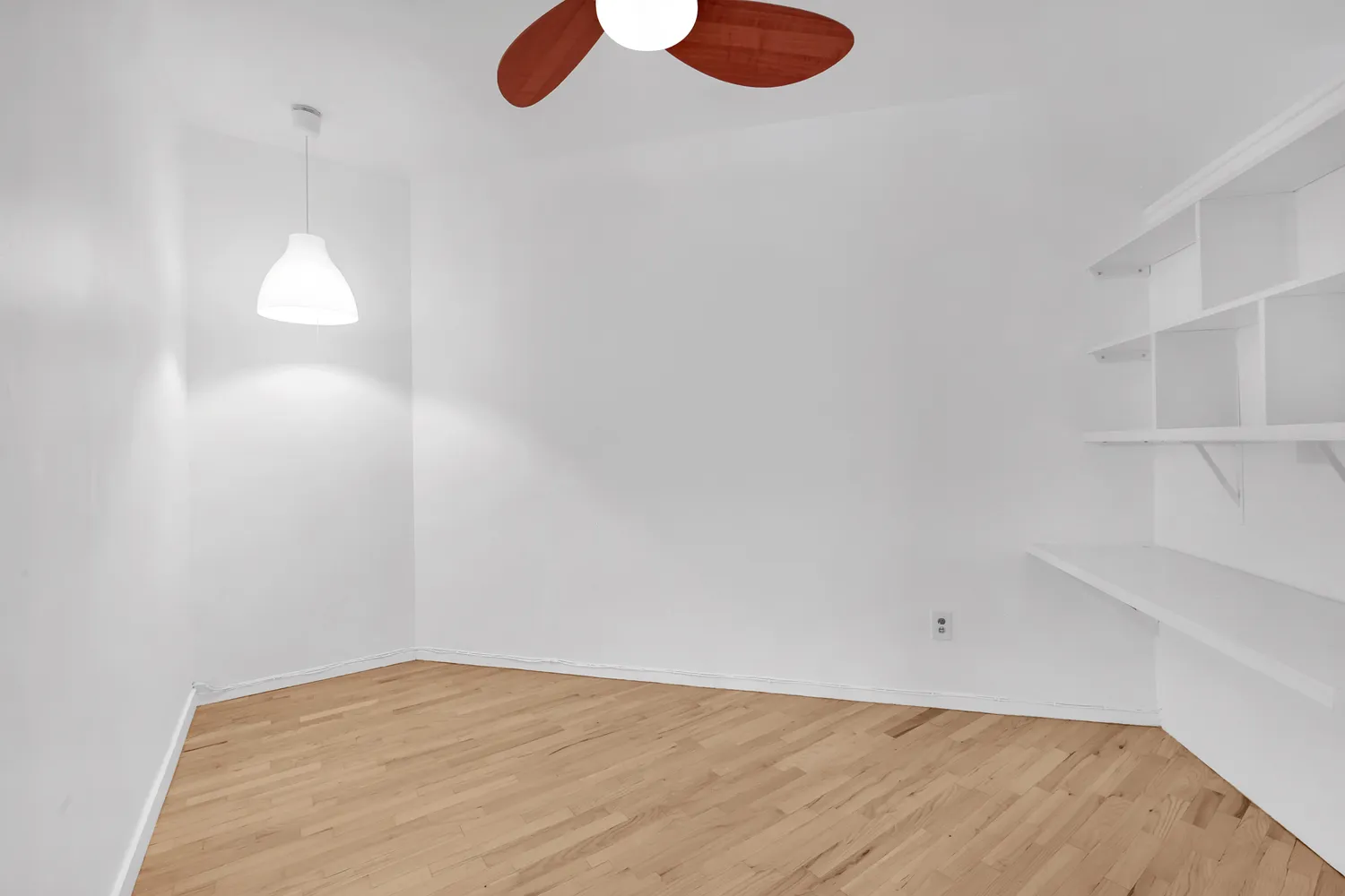 a view of a room with wooden floor and windows