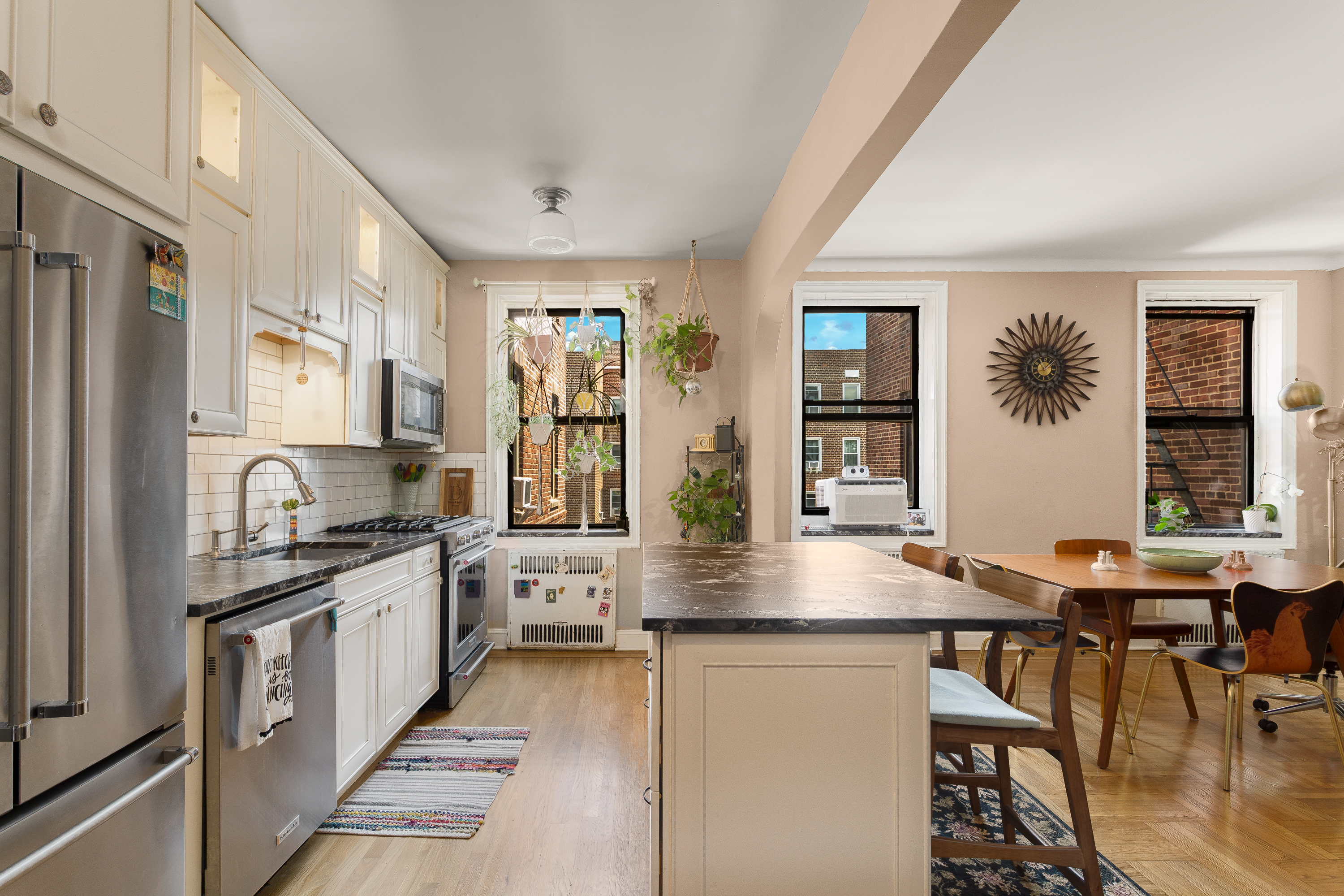 35-06 88th Street, Unit 5DD Queens, NY 11372 - Photo 9 of 18 a kitchen with stainless steel appliances granite countertop a stove and a sink
