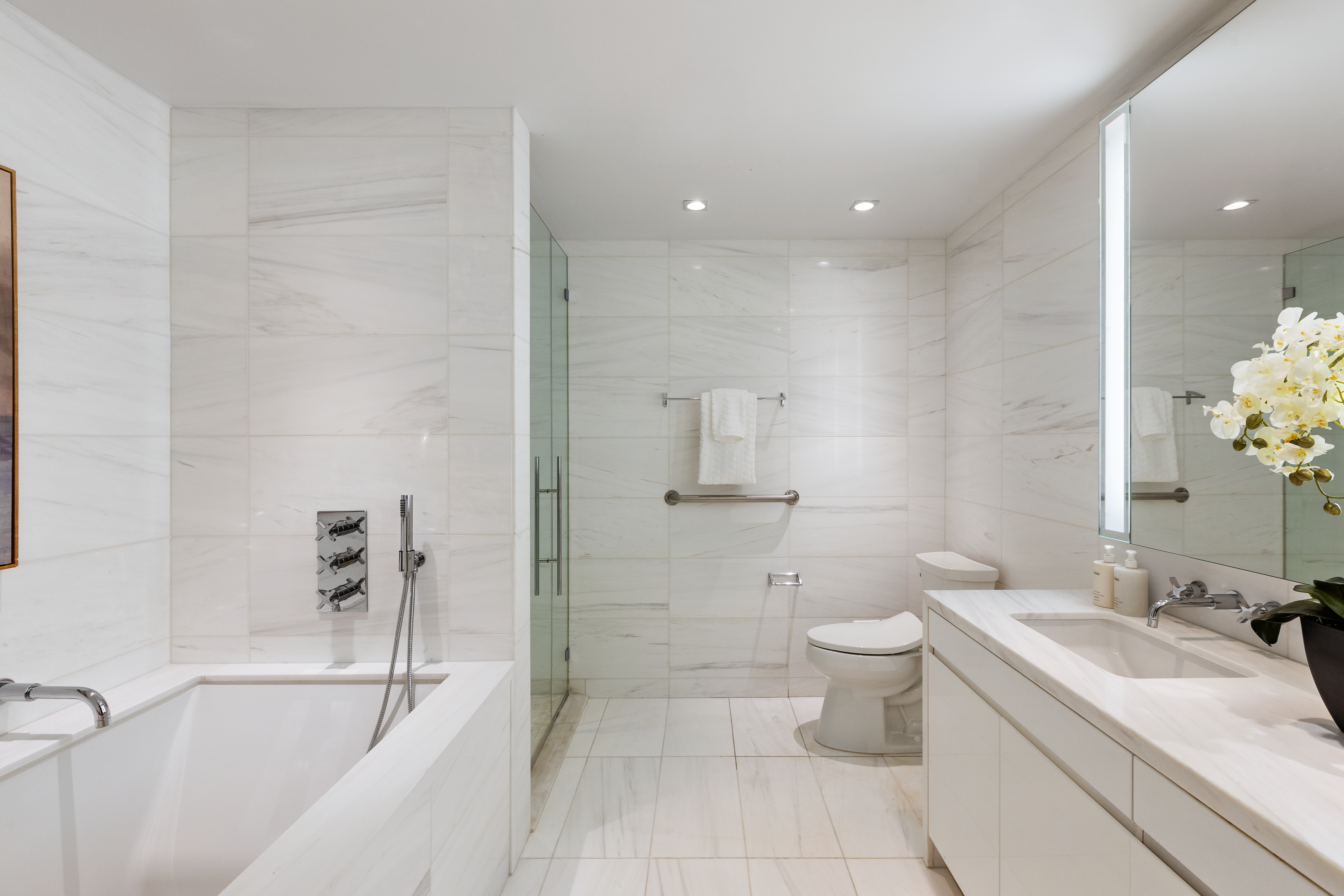 1355 1st Avenue, Unit 8 Manhattan, NY 10021 - Photo 16 of 25 a bathroom with a sink a toilet and shower