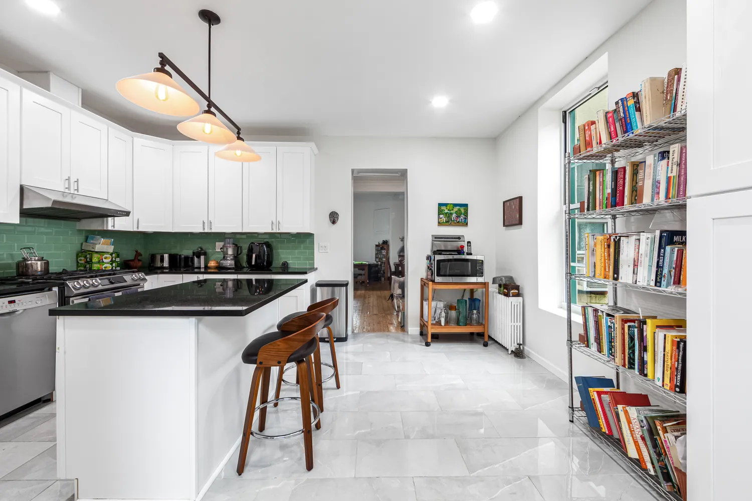 a kitchen with stainless steel appliances kitchen island granite countertop a refrigerator and a stove