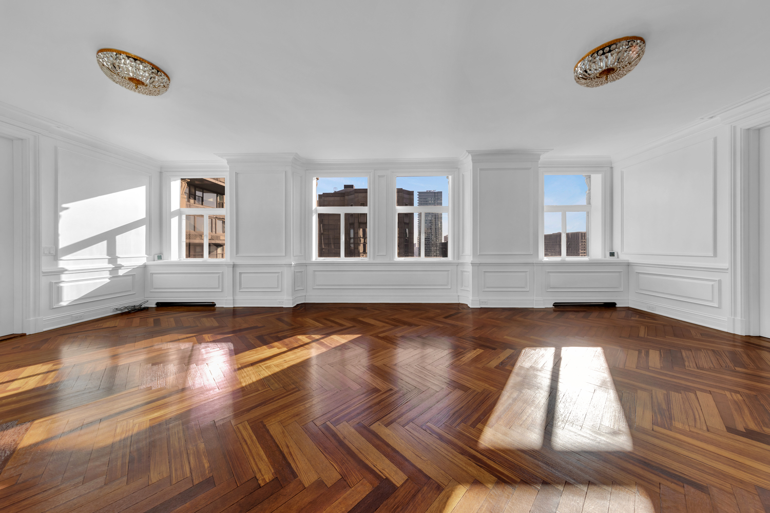 465 Park Avenue, Unit 34E Manhattan, NY 10022 - Photo 2 of 18 a view of an empty room with wooden floor and windows