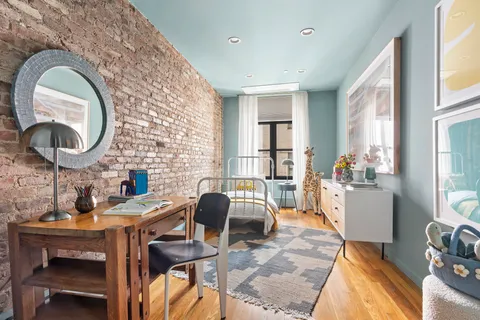 a work room with furniture and a mirror