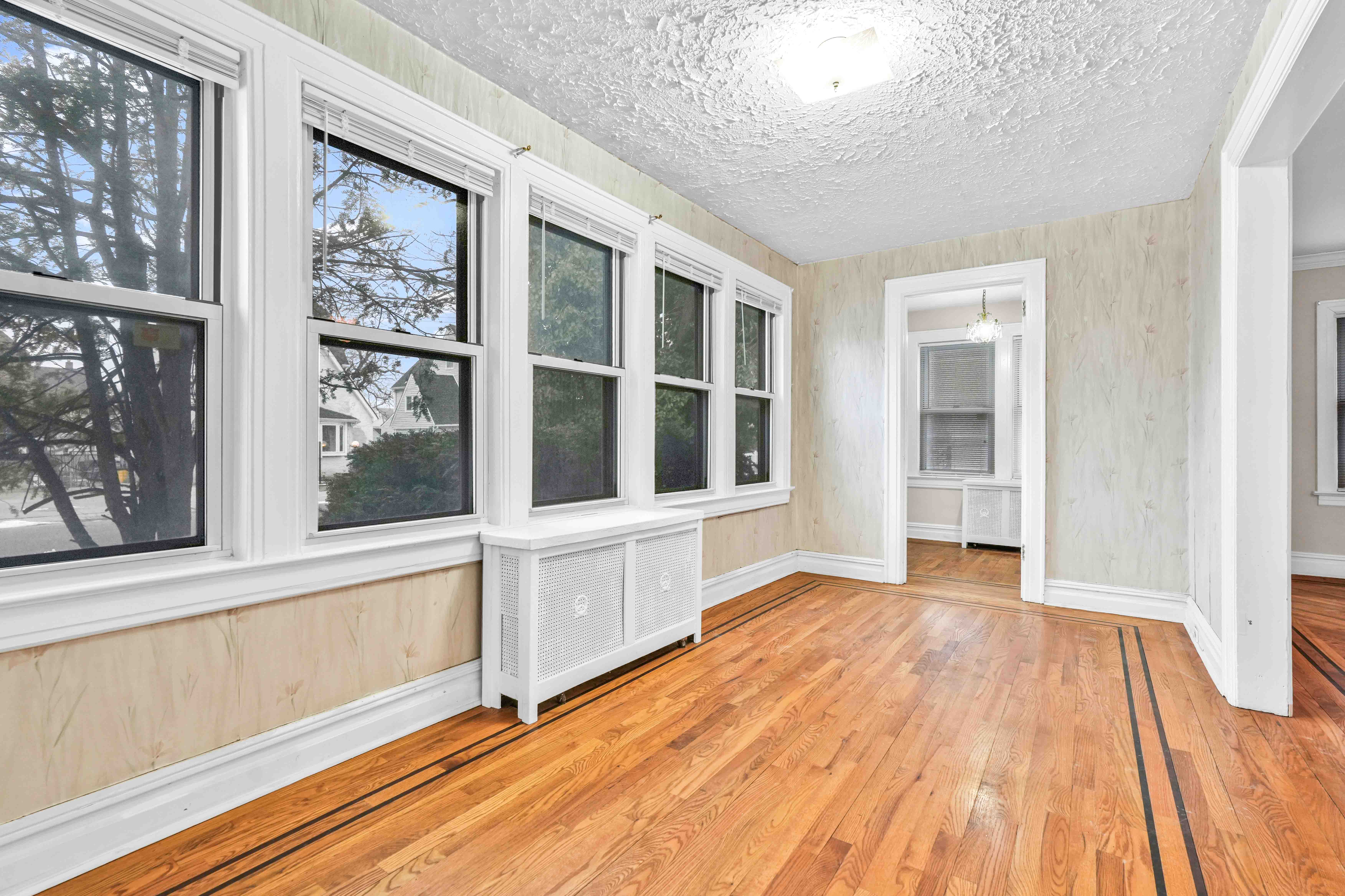 188-22 Lewiston Avenue, Unit 1 Queens, NY 11412 - Photo 3 of 17 wooden floor in an empty room with a window