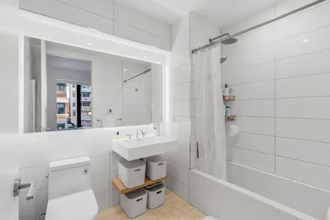 a bathroom with a sink toilet tub and shower