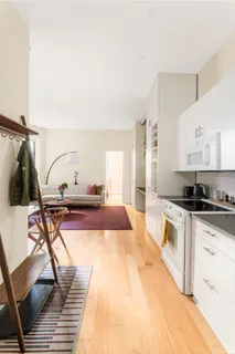 a living room with furniture a rug and white walls