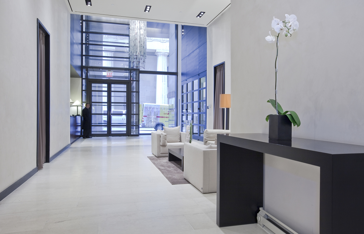 20 Pine Street, Unit 2905 Manhattan, NY 10005 - Photo 12 of 14 a living room with furniture and a potted plant