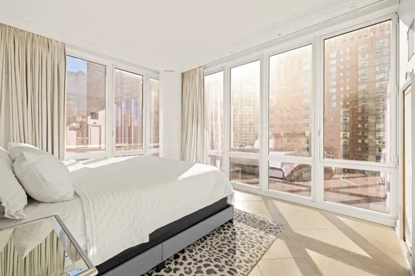 a bed sitting in a bedroom next to a window