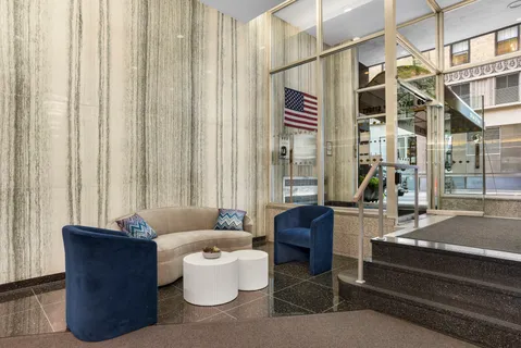 a living room with furniture and a potted plant