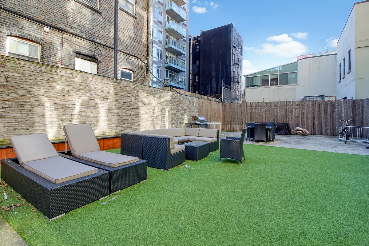 342 East 110th Street, Unit 5E Manhattan, NY 10029 - Photo 12 of 18 a wooden bench sitting in front of a building
