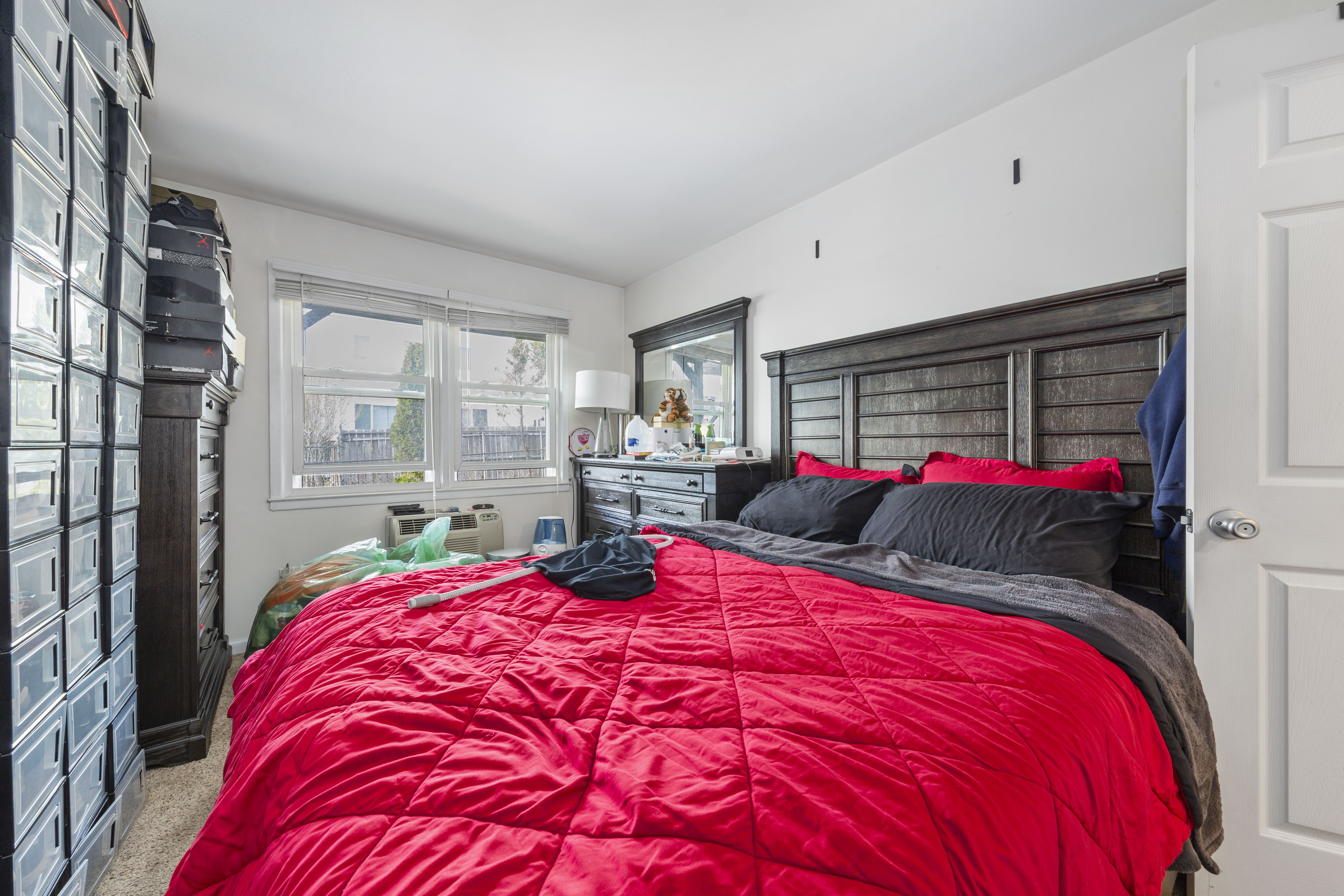 240-47 68th Avenue Queens, NY 11362 - Photo 12 of 39 a bed room with a bed and a large mirror