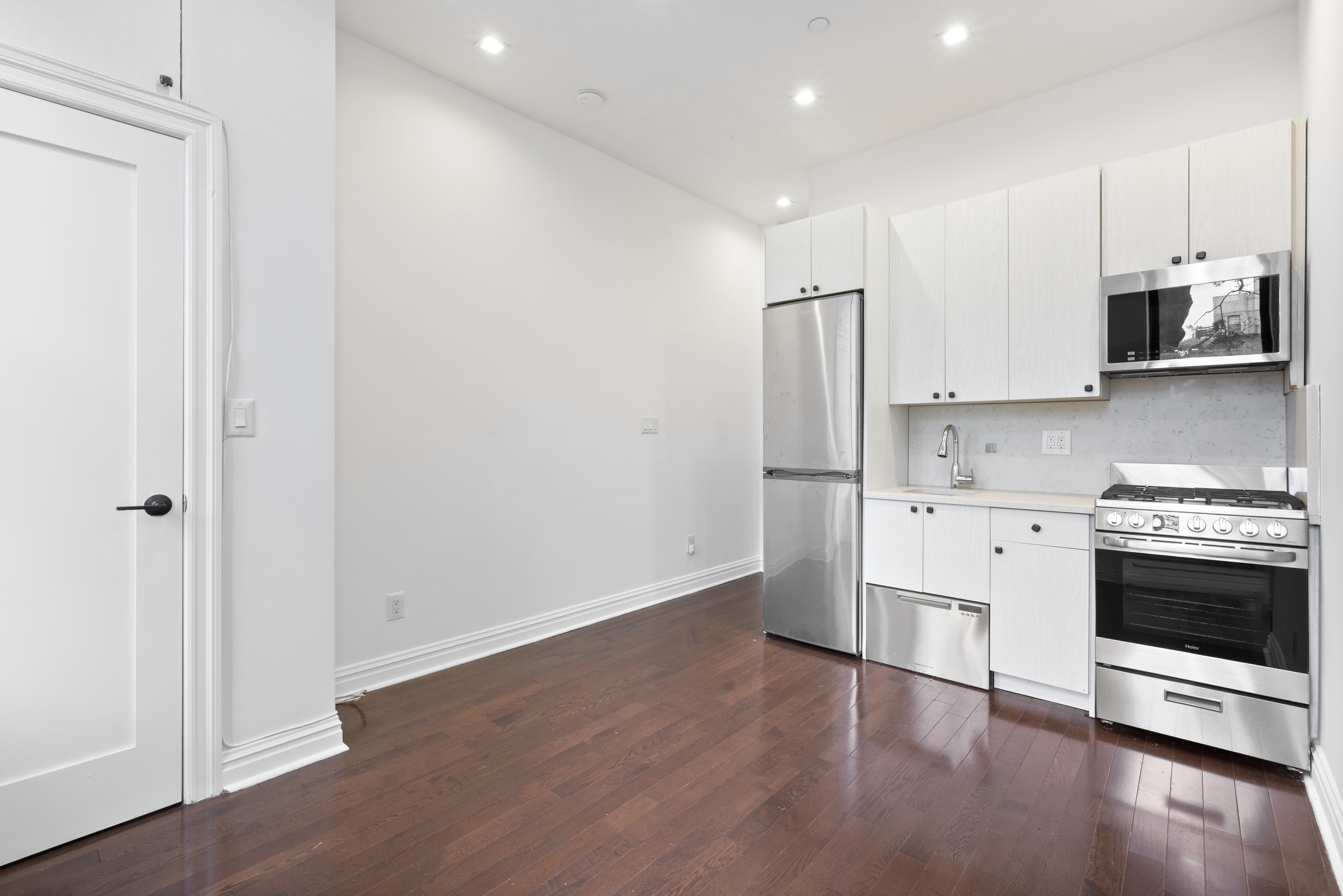 31 St Marks Place, Unit 10 Manhattan, NY 10003 - Photo 2 of 8 a kitchen with stainless steel appliances a refrigerator and a stove top oven