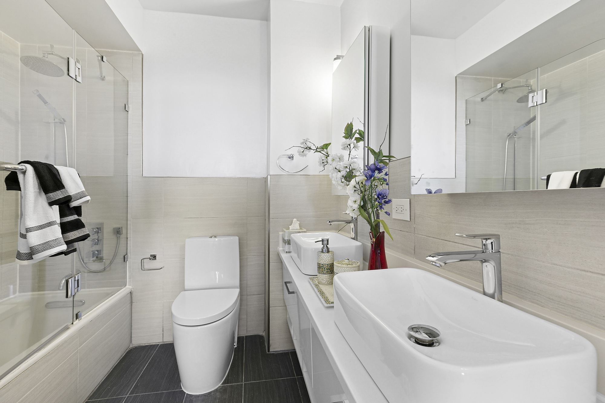 330 East 38th Street, Unit 50E Manhattan, NY 10016 - Photo 5 of 8 a bathroom with a sink a toilet and shower