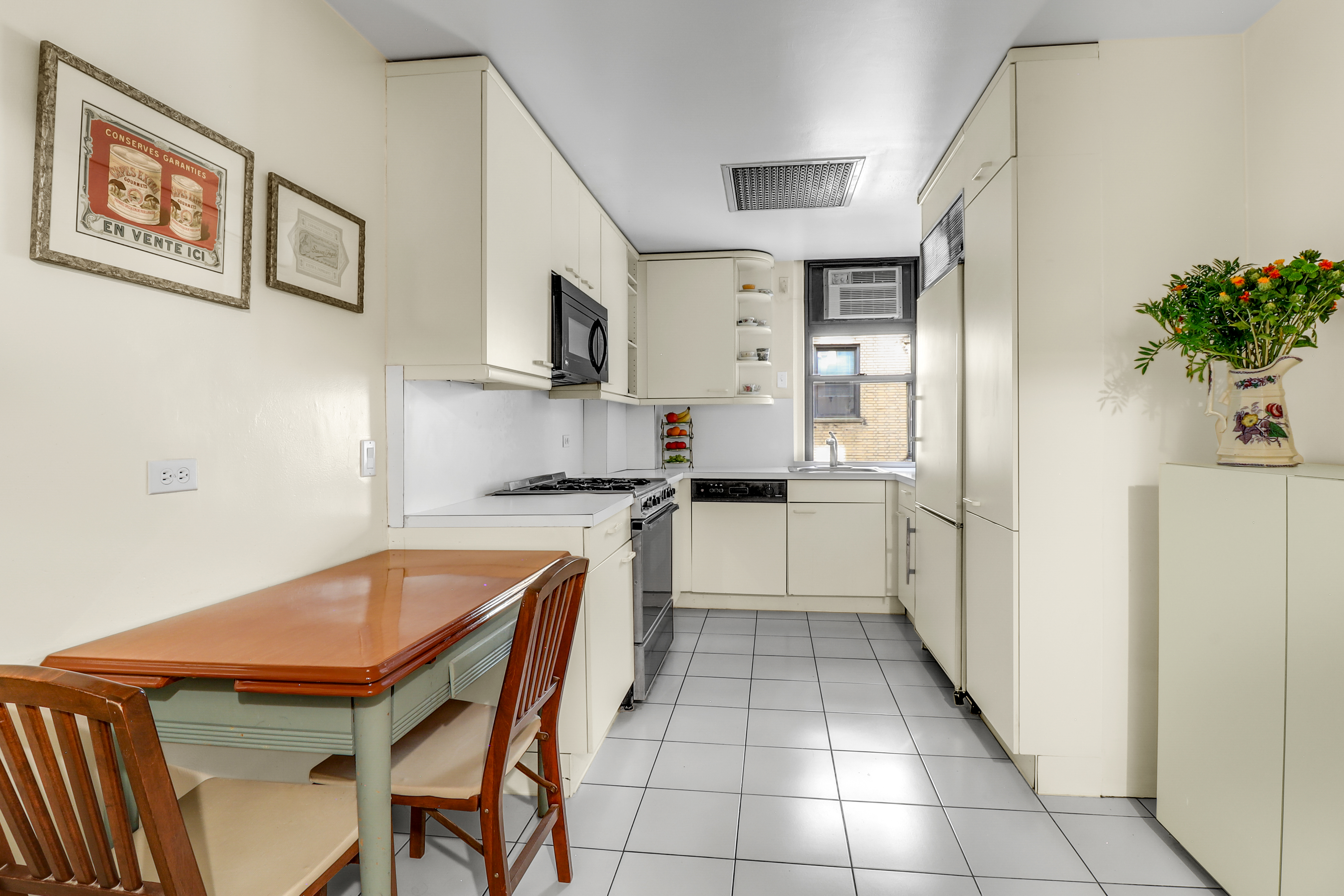 50 Riverside Drive, Unit 5E Manhattan, NY 10024 - Photo 5 of 22 a kitchen with stainless steel appliances granite countertop a refrigerator and a stove top oven