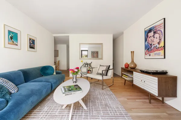 a living room with furniture and a wooden floor
