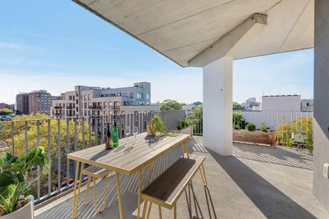 a view of a balcony with a table and chairs