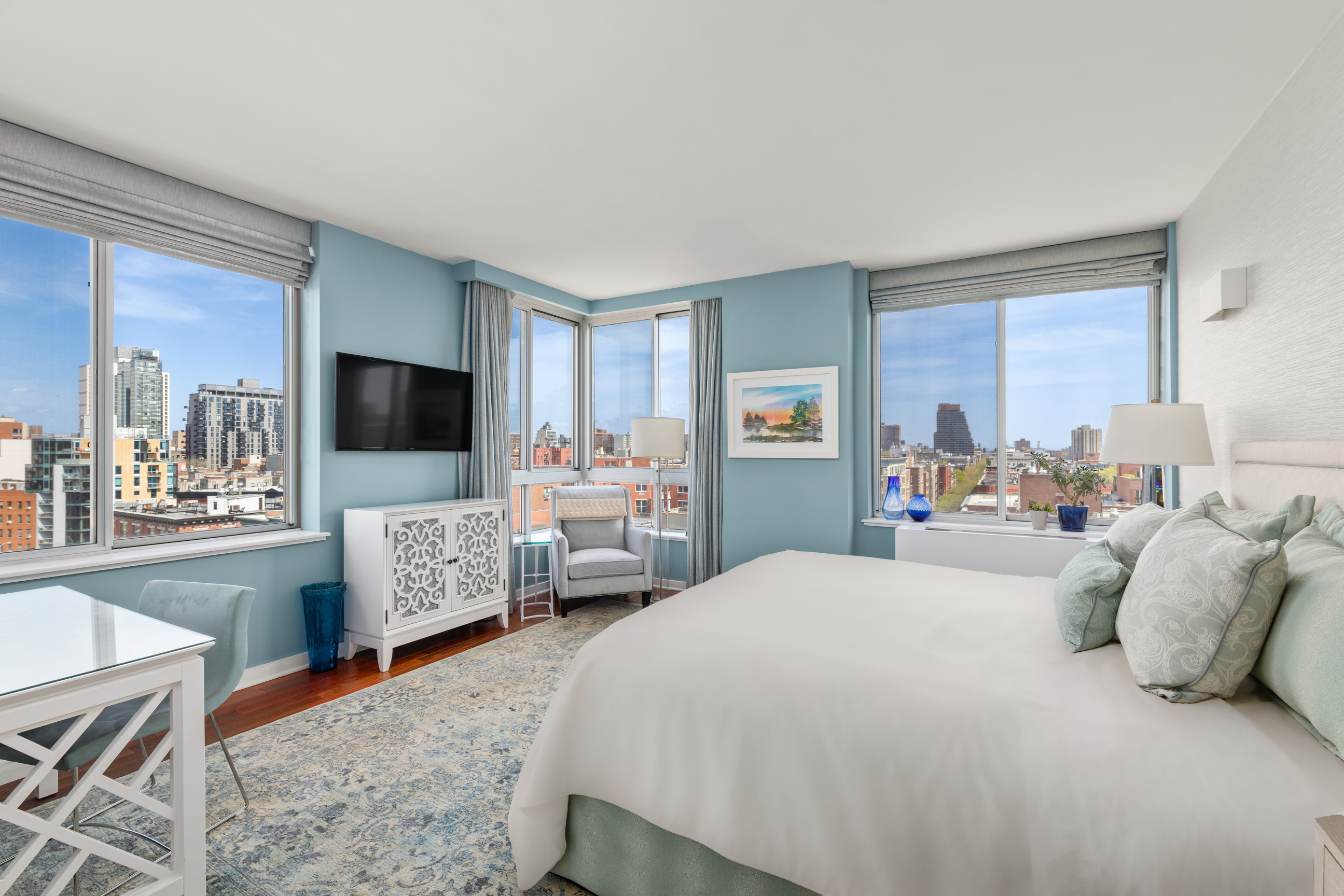 301 West 118th Street, Unit PH1C Manhattan, NY 10026 - Photo 4 of 12 a bedroom with a bed and a flat screen tv