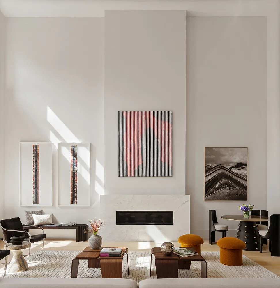 a living room with furniture and painting on the wall