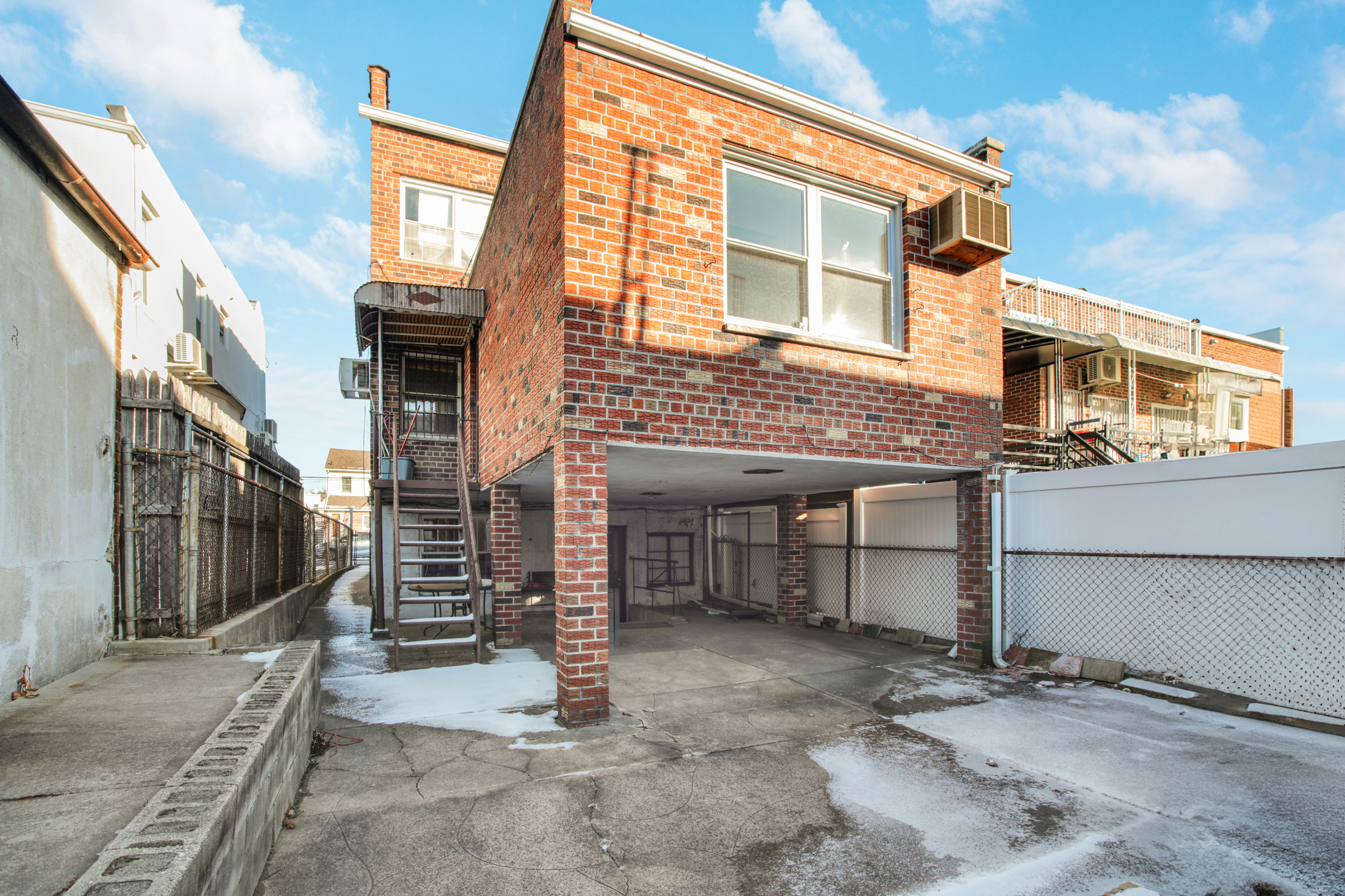 1986 West 13th Street Brooklyn, NY 11223 - Photo 9 of 11 a view of a house with a garage and balcony