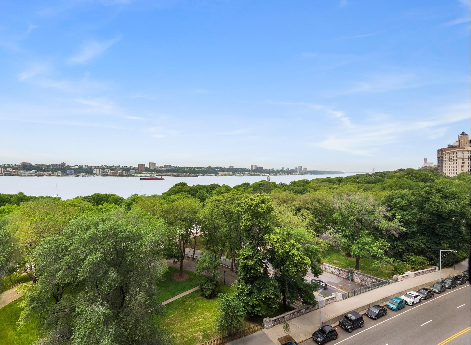 230 Riverside Drive, Unit 17D Manhattan, NY 10025 - Photo 2 of 18 a view of a lake with houses in the back