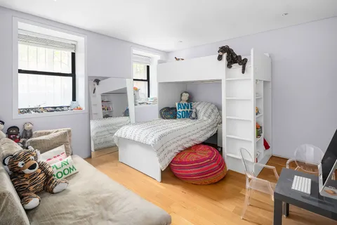 a bedroom with furniture and a window