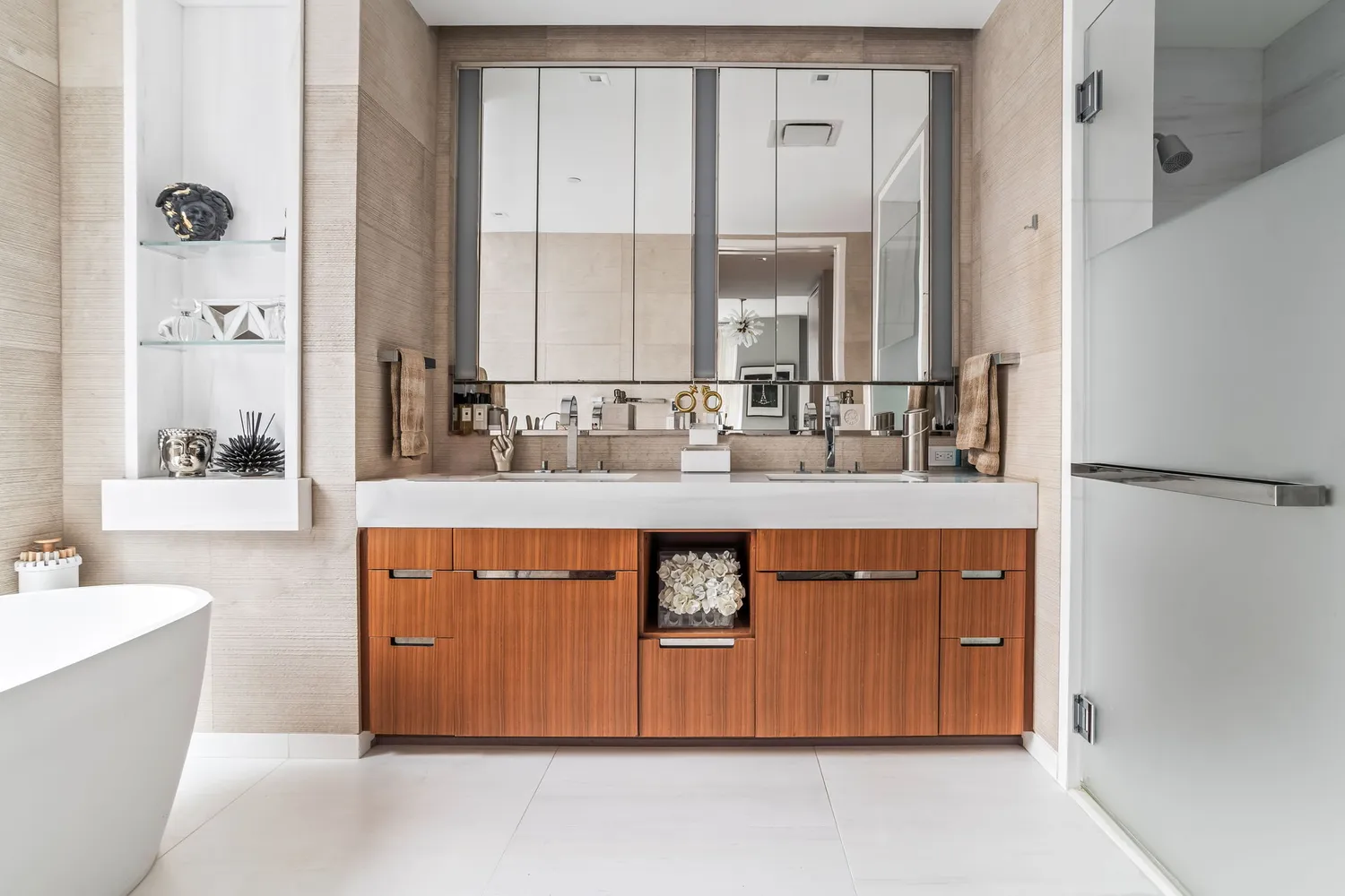 a bathroom with a double vanity sink a mirror and a bathtub