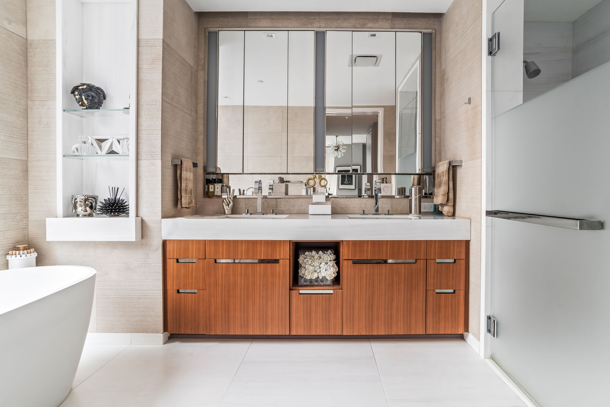 1 West End Avenue, Unit 9D Manhattan, NY 10023 - Photo 10 of 22 a bathroom with a double vanity sink a mirror and a bathtub