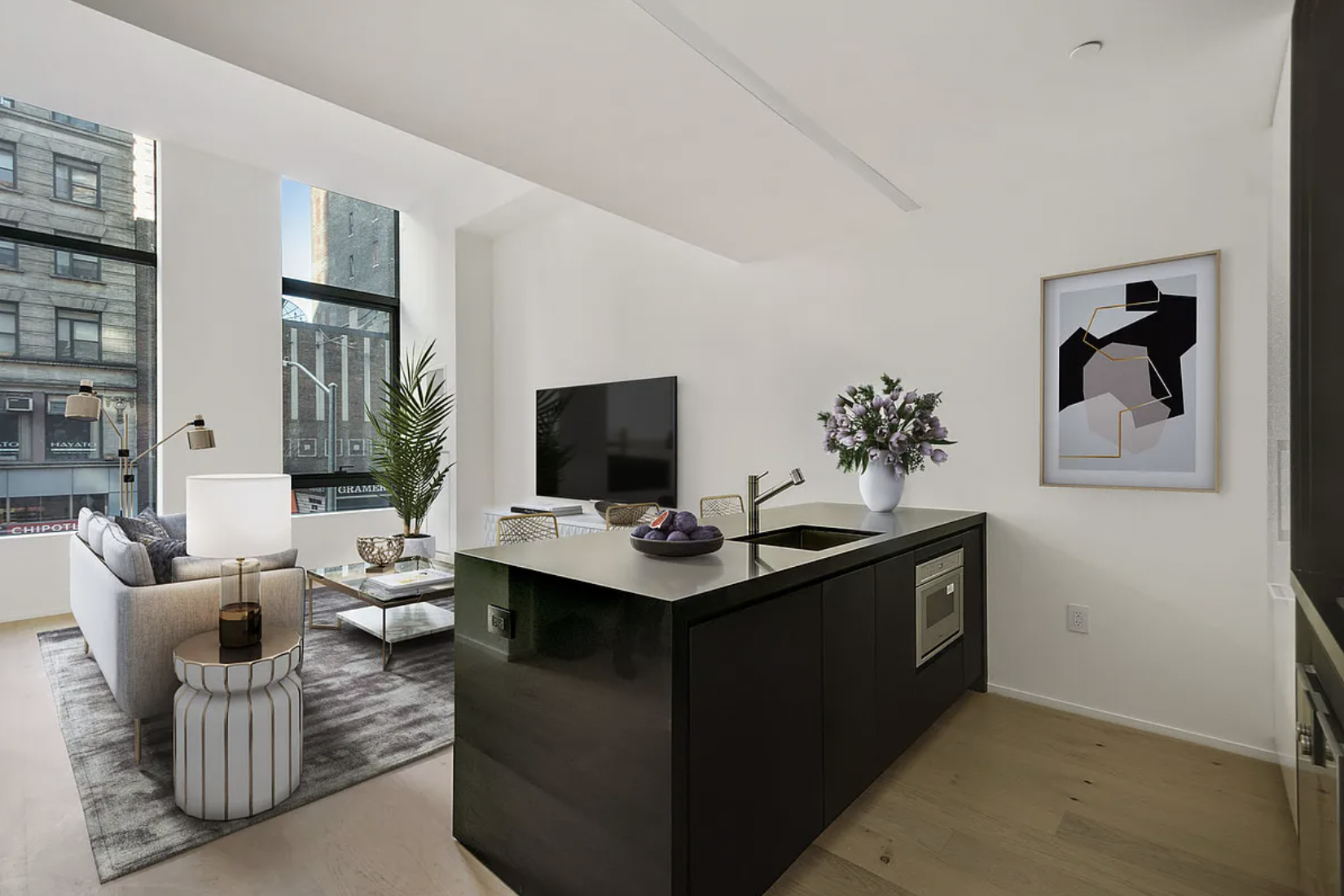 121 East 22nd Street, Unit N203 Manhattan, NY 10010 - Photo 3 of 10 a view of a livingroom with workspace and a couch