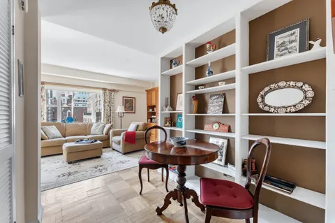 a living room with furniture a rug and a window