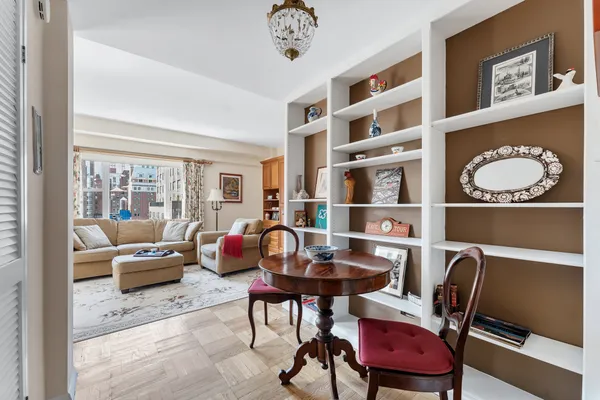a living room with furniture a rug and a window