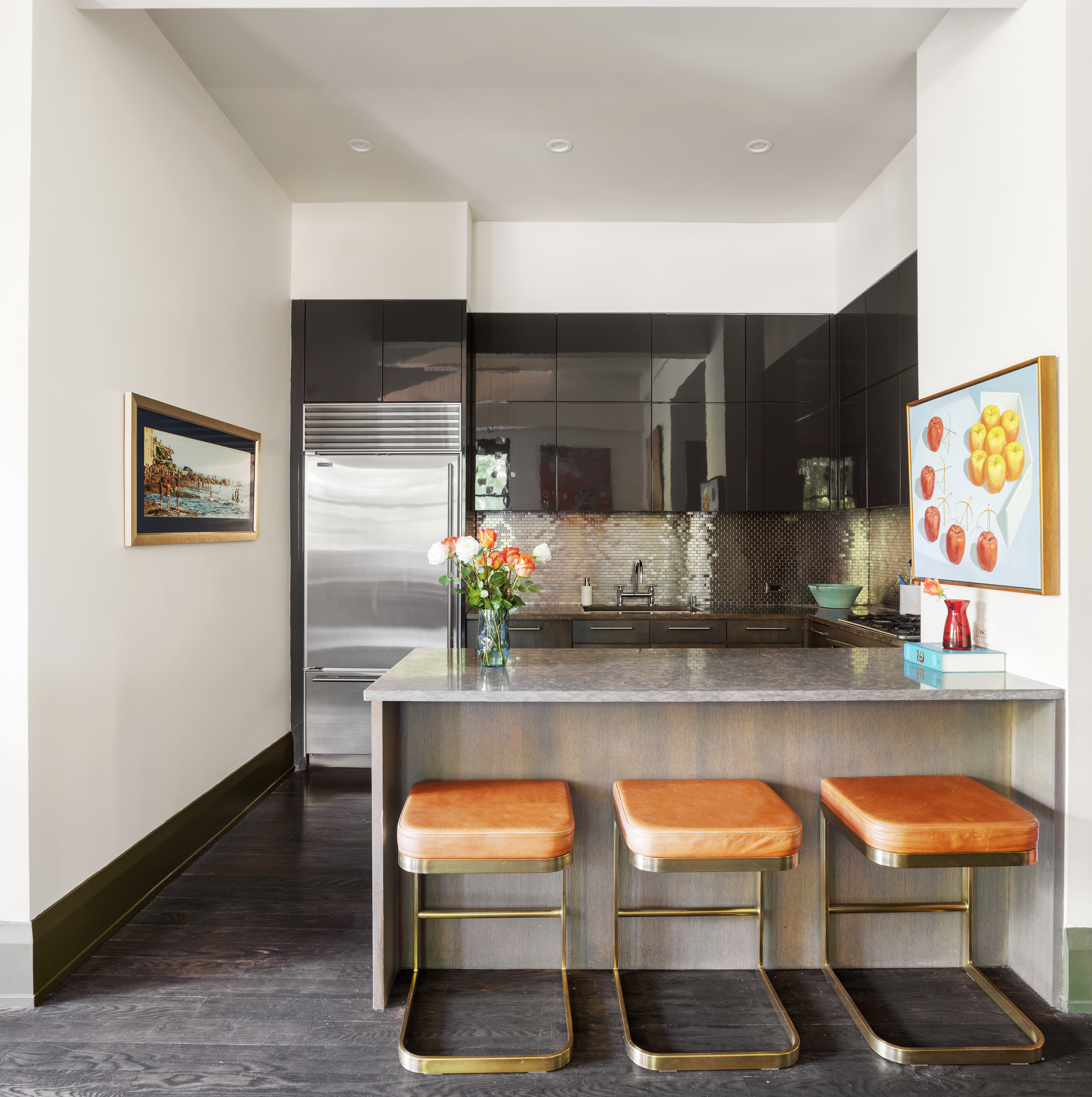 263 9th Avenue, Unit 2E Manhattan, NY 10001 - Photo 3 of 12 a kitchen with stainless steel appliances kitchen island granite countertop a table and chairs in it