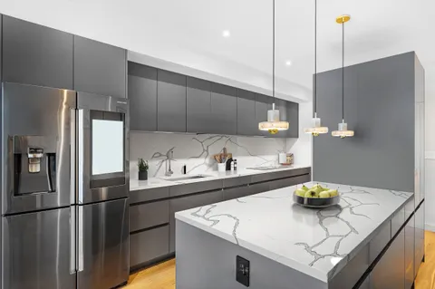 a kitchen with a sink a refrigerator and a stove