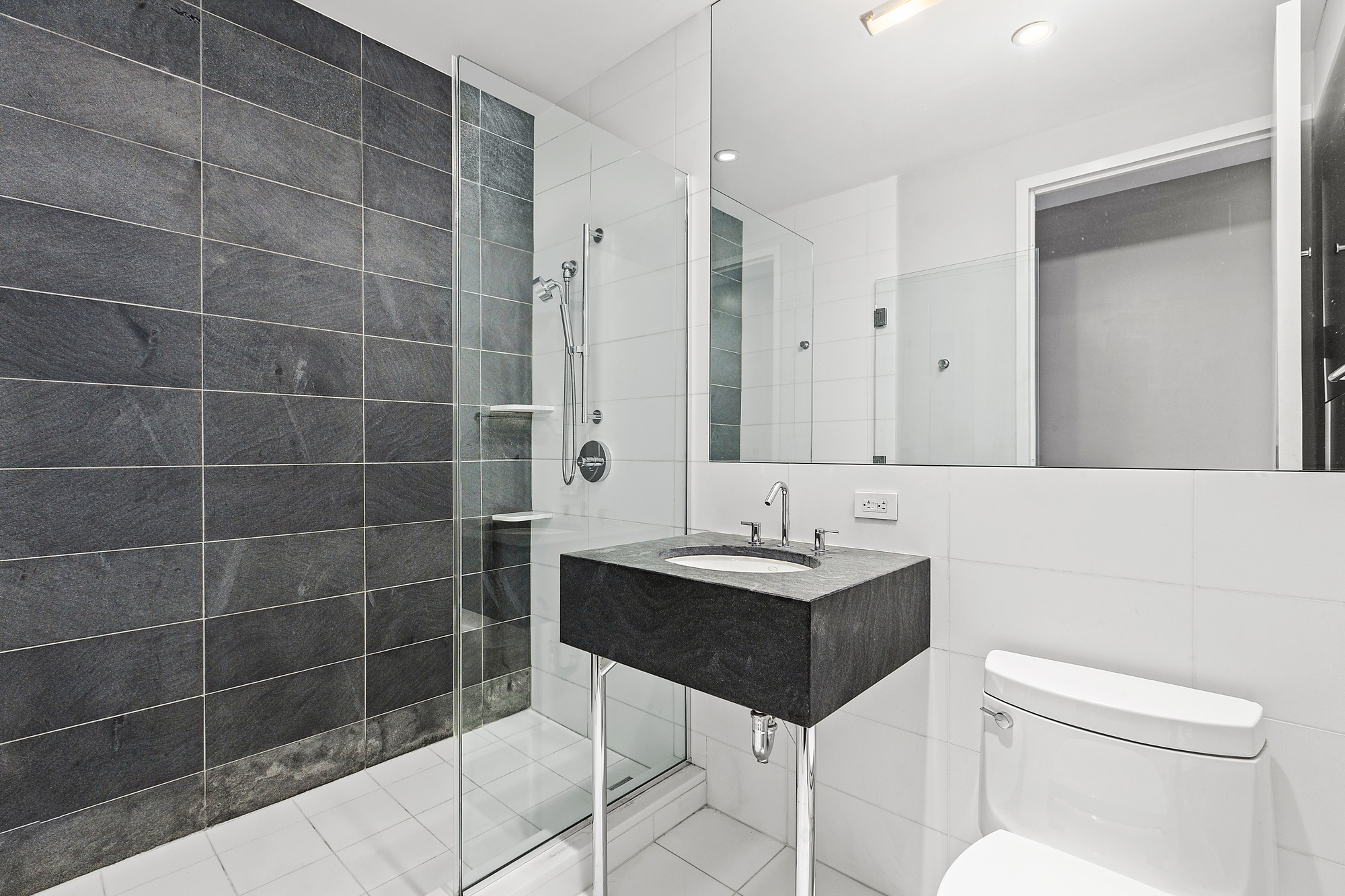 4 West 21st Street, Unit 11A Manhattan, NY 10010 - Photo 7 of 9 a bathroom with a sink a toilet and shower