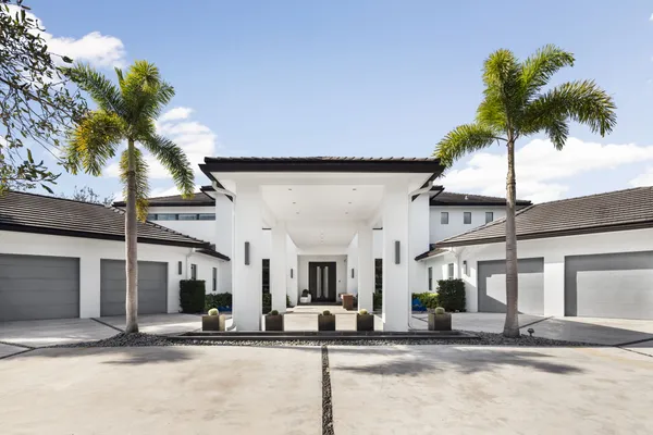 a house with palm tree in front of it