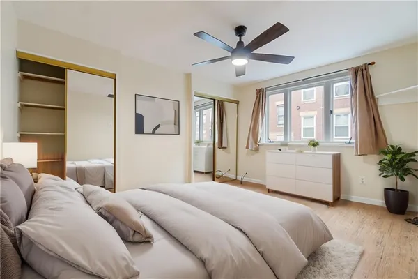 a bedroom with a large bed and a large window