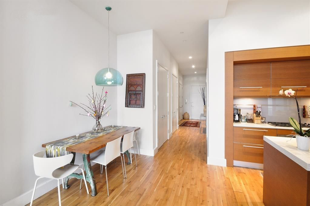 360 Furman Street, Unit 511 Brooklyn, NY 11201 - Photo 4 of 37 a view of a living room and kitchen with furniture wooden floor