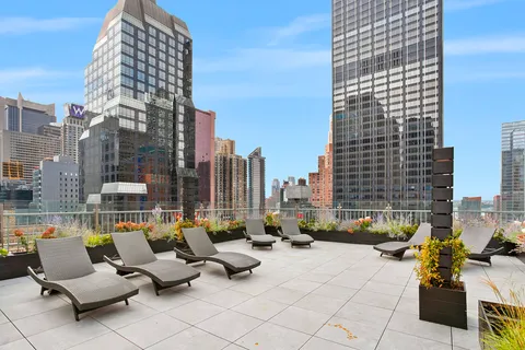 a view of balcony with couch and chairs