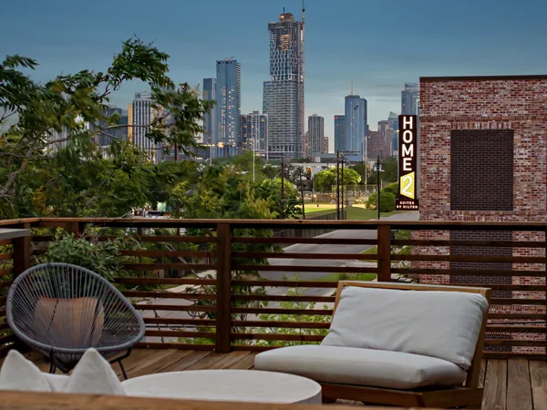 a balcony with furniture and a potted plant
