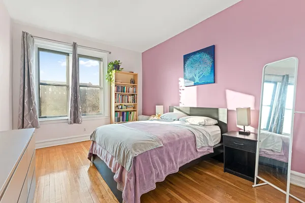 a bedroom with a bed and a large window