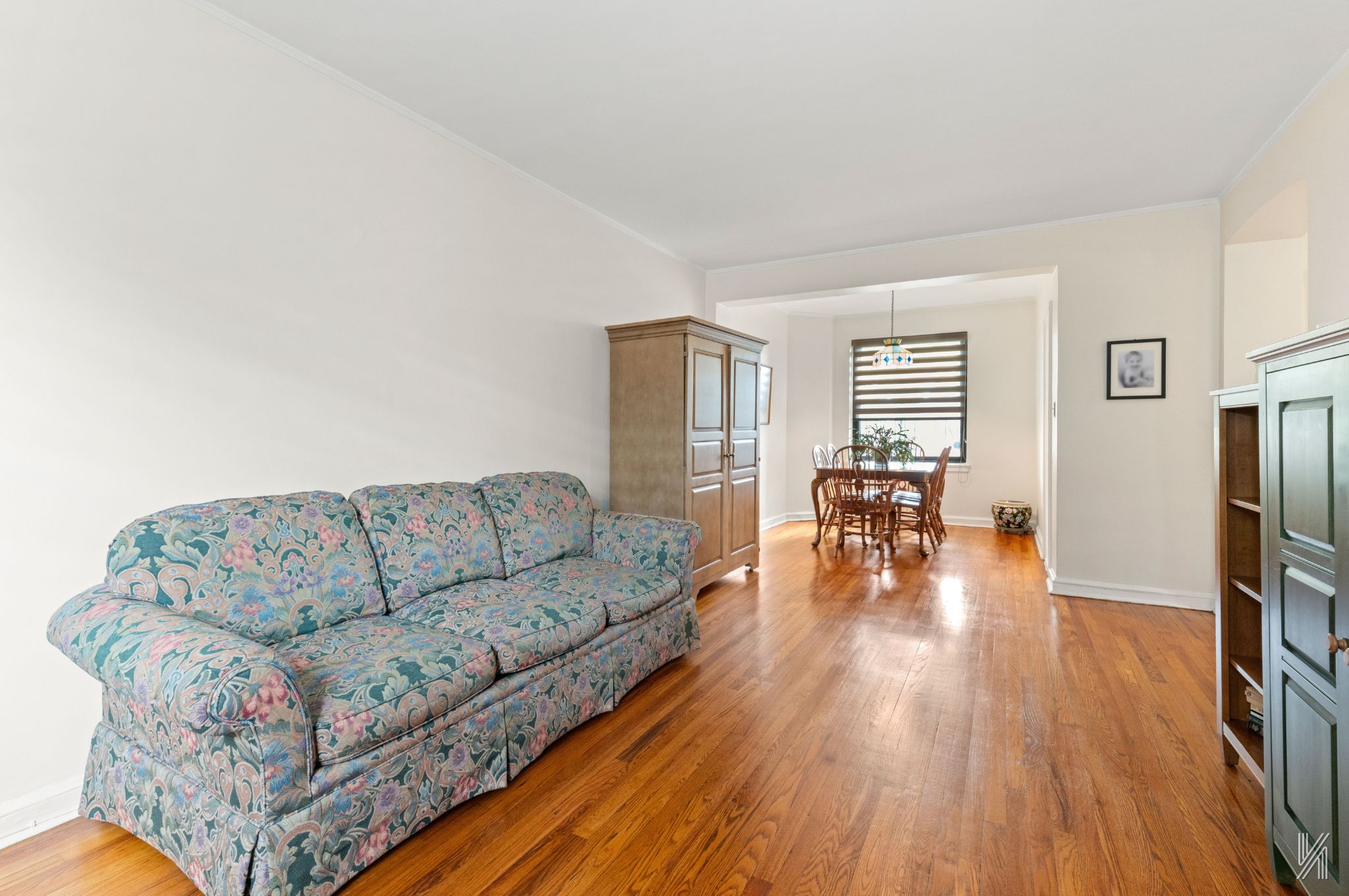 22-08 76th Street, Unit D2 Queens, NY 11370 - Photo 6 of 20 a living room with furniture and a wooden floor