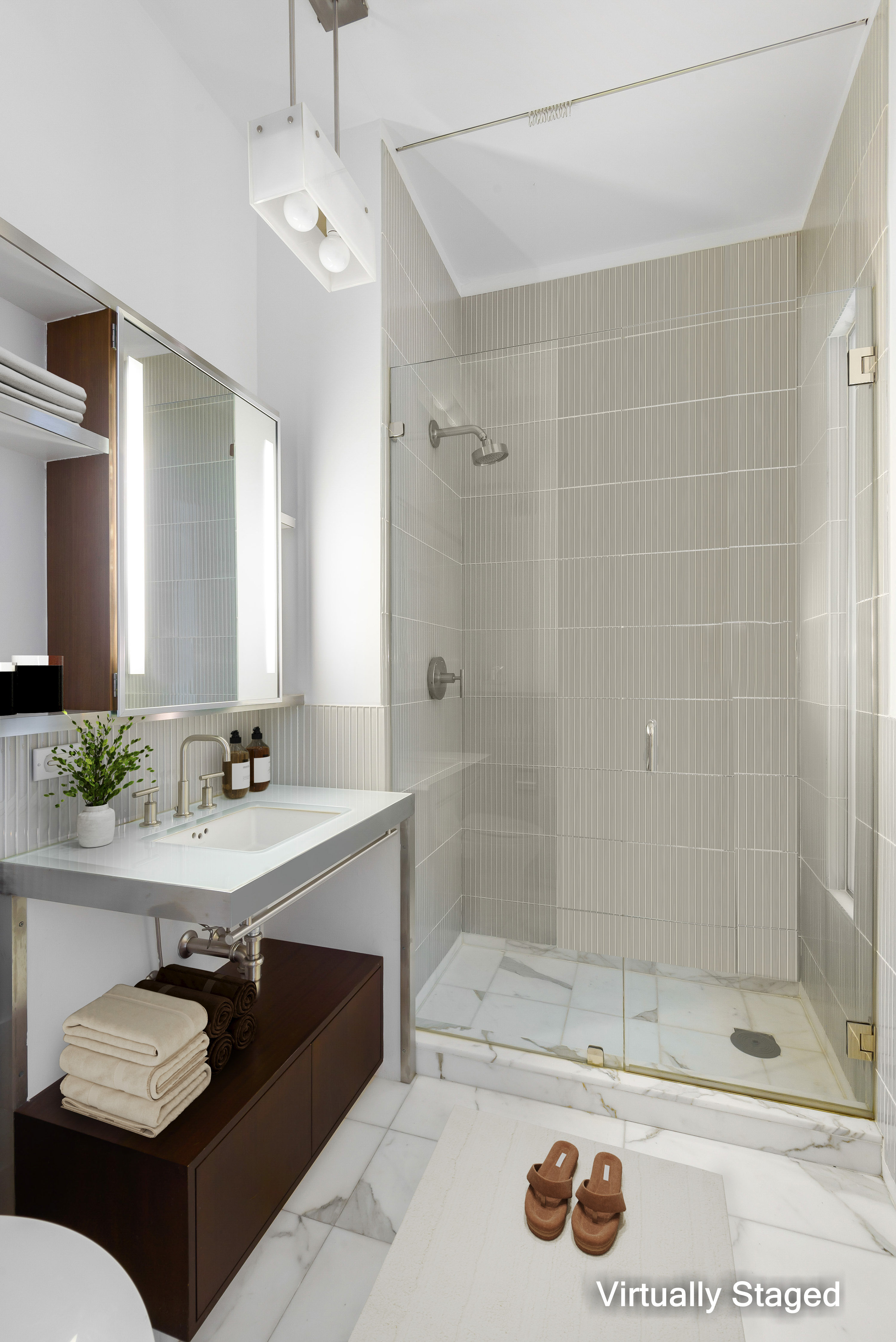 40 Mercer Street, Unit 19 Manhattan, NY 10013 - Photo 7 of 16 a bathroom with a sink a toilet and shower