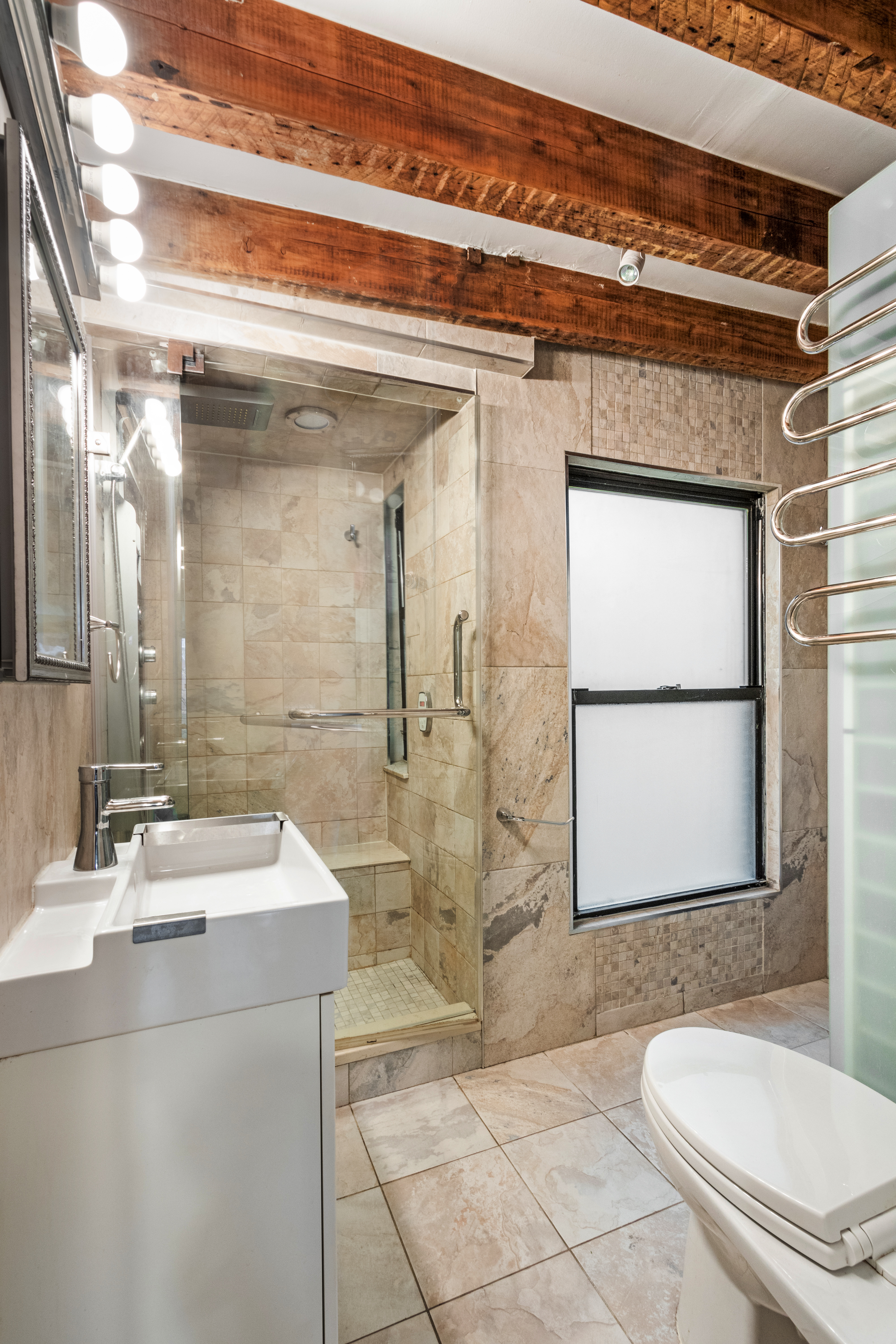 88 East 3rd Street, Unit 15 Manhattan, NY 10003 - Photo 5 of 6 a bathroom with a sink a toilet and shower